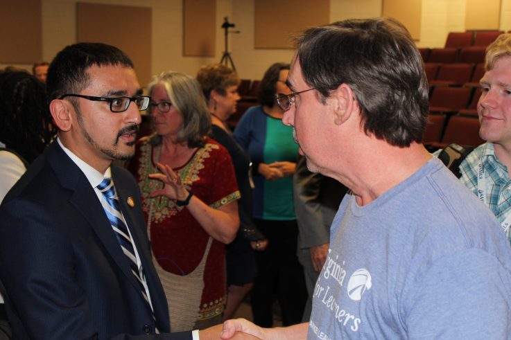Image of Secretary Qarni greeting ESCC Faculty member Bob Rhea.